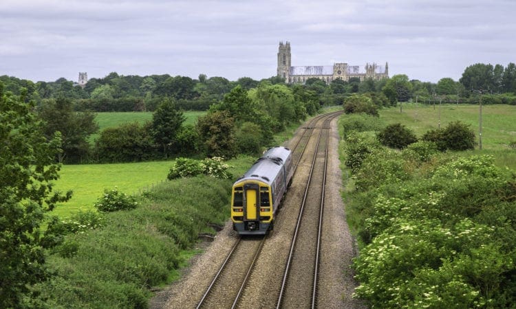 Railway train in rural landscape with minster, Beverley, Yorkshire, UK.