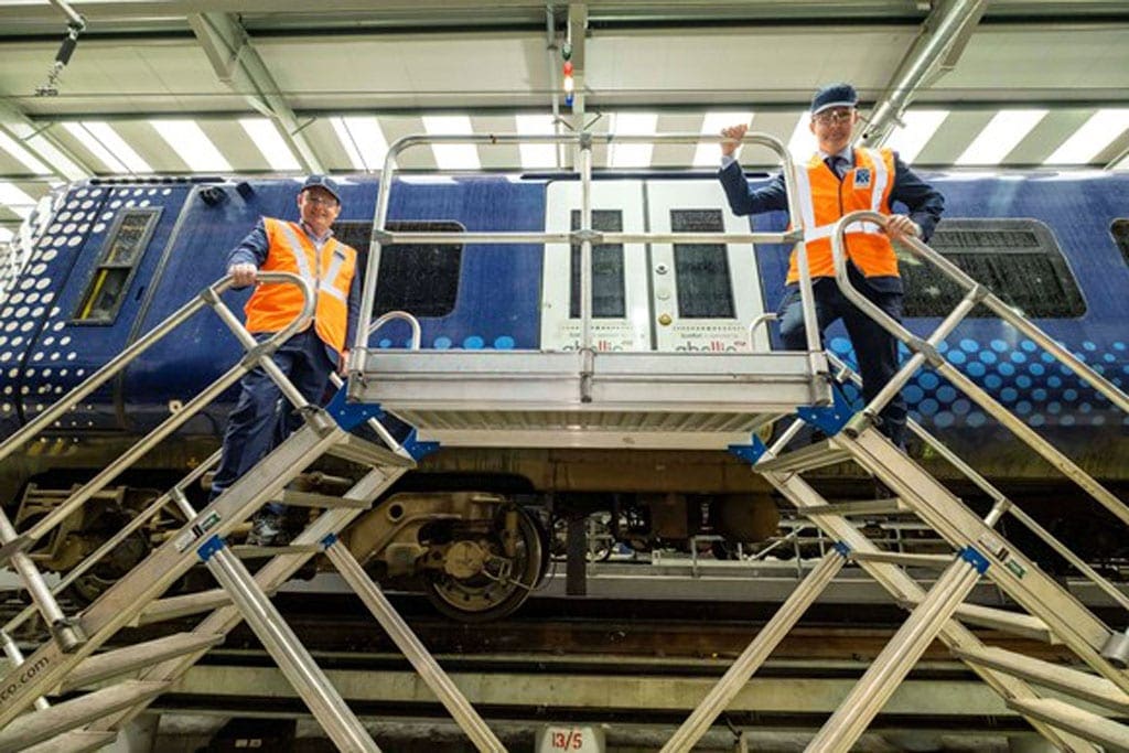 Scotland rail workers pose with Abellio carriage