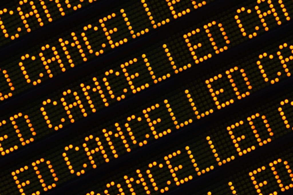 A Close Up Of The Word Cancelled Repeated Multiple Times On A Sign At A Station Or Airport