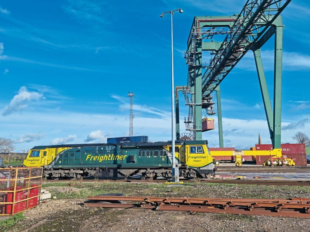 A blue sky at Freightliner’s Southampton Maritime Terminal with a train moving along the track